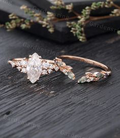 a close up of a ring on a wooden surface with flowers in the back ground