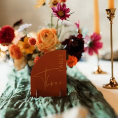 a table with flowers and candles on it