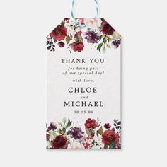 a wedding thank card with red and purple flowers