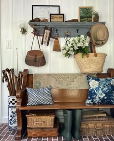 a wooden bench sitting next to a wall filled with baskets and other items on top of it