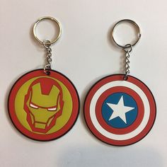 two captain america key chains are shown on a white surface