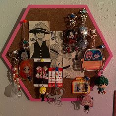 a bulletin board covered in lots of cartoon character magnets and charms on it's side