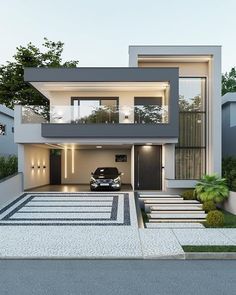 a car is parked in front of a modern house with steps leading up to it