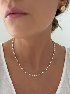 "D E T A I L S - 18K Gold Filled, Freshwater Pearls Synthetic - 16\" length with a 2\" extender - Lobster Clasp  M A T E R I A L S At Dylan Rae, we are committed to handcrafting jewelry that is perfect for everyday wear. Our high-quality gold filled designs contain 100+ times more real gold than gold plated components. The thick outer layer of gold makes it highly durable and safe for people with allergies or sensitive skin. C A R E Care for Your Gold Filled Jewelry: Wear It, Love It, Care for It! Our gold-filled pieces are crafted to be your lifelong companions. Feel free to wear them every day, even while showering, but remember to avoid exposing them to saltwater and chlorine. These elements can diminish their luster over time and may even cause oxidation if they come in contact with yo Affordable 8mm Bead Pearl Necklace, Dainty Single Strand White Chain Necklace, Dainty White Single Strand Chain Necklace, Dainty White Adjustable Chain Necklace, Dainty White Necklace With Pearl Drop, Dainty White Pearl Drop Necklace, Delicate Single Strand Bridal Necklace, Dainty Single Strand Beaded Necklaces For Wedding, White Dainty Beaded Necklace With Adjustable Chain