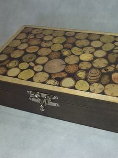 a wooden box filled with lots of different types of wood slices on top of it