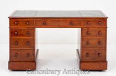 an antique wooden desk with drawers and knobs