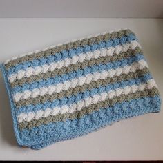 a blue and white crocheted dishcloth sitting on top of a table