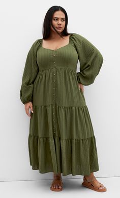 Elevate your style with the Portia Dress. Feel radiant with its button down front closure and long elasticated sleeves. Complete with a tiered maxi length skirt, this dress is perfect from day to night. Key Features Include: - V-neckline - Long elasticated sleeves - Button down front closure - Shirred elasticated side panels - Relaxed fit - Pull over style - Fully lined - Side pockets - Tiered maxi length skirt | Plus Size Portia Dress in Dark Olive, Size 16 | City Chic Plus Size Soft Natural, Date Night Plus Size, Soft Natural Kibbe, Plus Size Soft, Natural Kibbe, Big Size Fashion, Olive Dress, Skirt Plus Size, Style Essentials