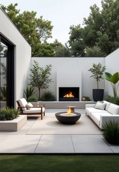 an outdoor living area with couches and fire pit