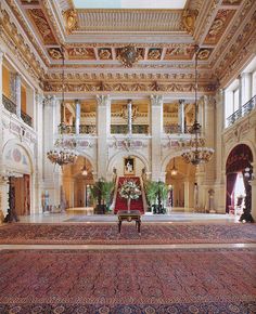 an ornately decorated room with chandeliers and rugs