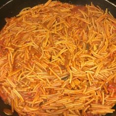 a pan filled with pasta and sauce on top of a stove