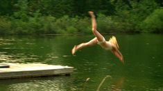 a person jumping into the water from a dock