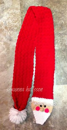 a knitted santa claus hat and scarf