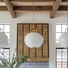 a kitchen with two hanging lights above the stove