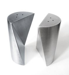 two metal objects sitting next to each other on a white surface