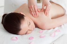 a woman getting a back massage at the spa - stock photo - images