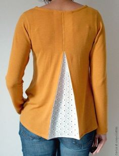 the back of a woman's yellow sweater with white polka dots and an open front