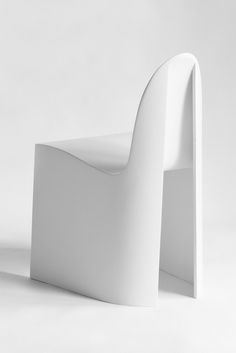 a white chair sitting on top of a white floor