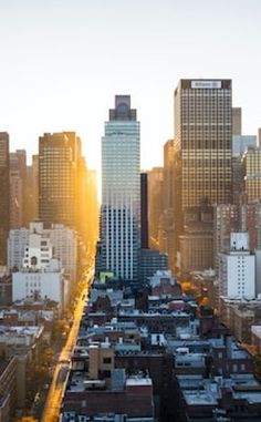 an aerial view of the city with tall buildings and skyscrapers in the foreground