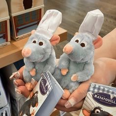 two stuffed mouses in chef's hats are on display at a toy store