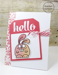 a handmade card with an image of a bunny holding a hello tag on it