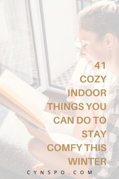 a woman reading a book with the words cozy indoor things you can do to stay comfy this winter