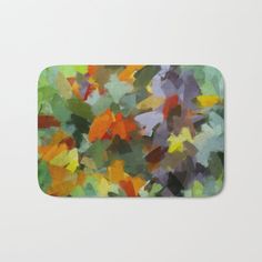 an abstract painting of colorful leaves on a white background bath mat with the colors of green, orange, yellow and red