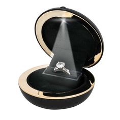 an open box with a ring in it