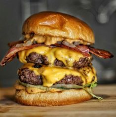 a cheeseburger with bacon, lettuce and other toppings