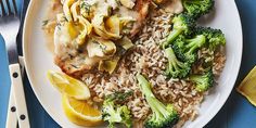 a white plate topped with chicken, rice and broccoli