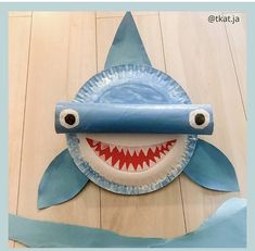 a paper plate shaped like a shark with its mouth wide open and teeth hanging out