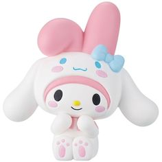 an adorable little toy sitting on top of a white surface with pink ears and blue eyes