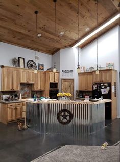 a kitchen with wooden cabinets and an industrial style island in the middle of the room