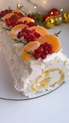 there is a cake with oranges and cranberries on the top of it