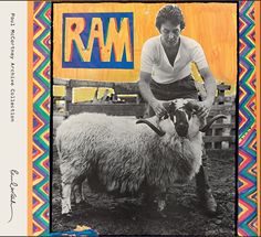 a woman kneeling down next to a sheep in front of a sign that says ram