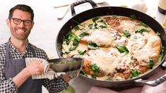 a man holding a pan filled with food next to a pot full of chicken and spinach