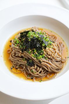 a white bowl filled with noodles and broccoli