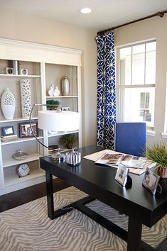 a living room filled with lots of furniture and bookshelves next to a window