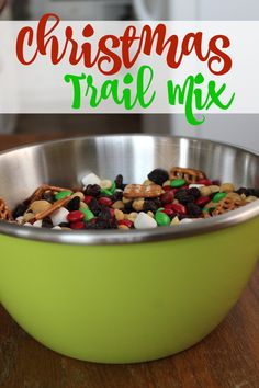 a green bowl filled with christmas trail mix