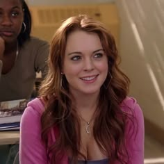 two women sitting next to each other at a table