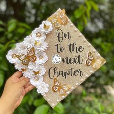 someone holding up a graduation cap with butterflies on it that says on to the next charter