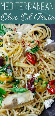 a close up of a plate of pasta with olives, peppers and parmesan cheese