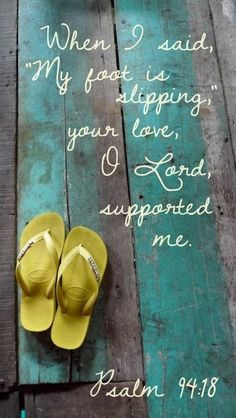 a pair of yellow slippers sitting on top of a wooden floor next to a bible verse