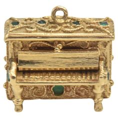 an antique gold jewelry box with green stones