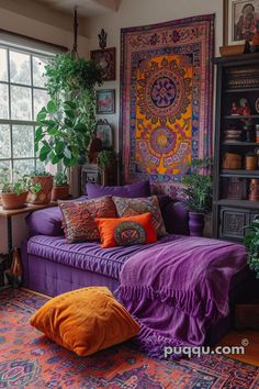 a living room filled with lots of purple furniture and plants on top of the windowsill