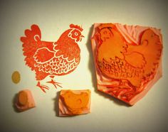 an orange stamp with a chicken on it next to some other stamps that have been cut out