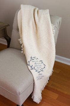 a white blanket sitting on top of a chair