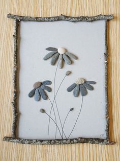 some rocks are placed in a frame on a table