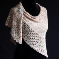 a knitted shawl on a mannequin