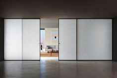 an empty room with white walls and sliding doors